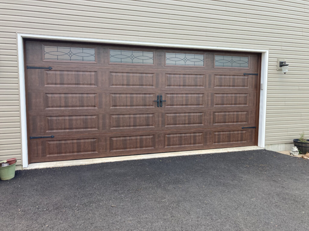 faux wood traditional garage doors with decrotive windows.
