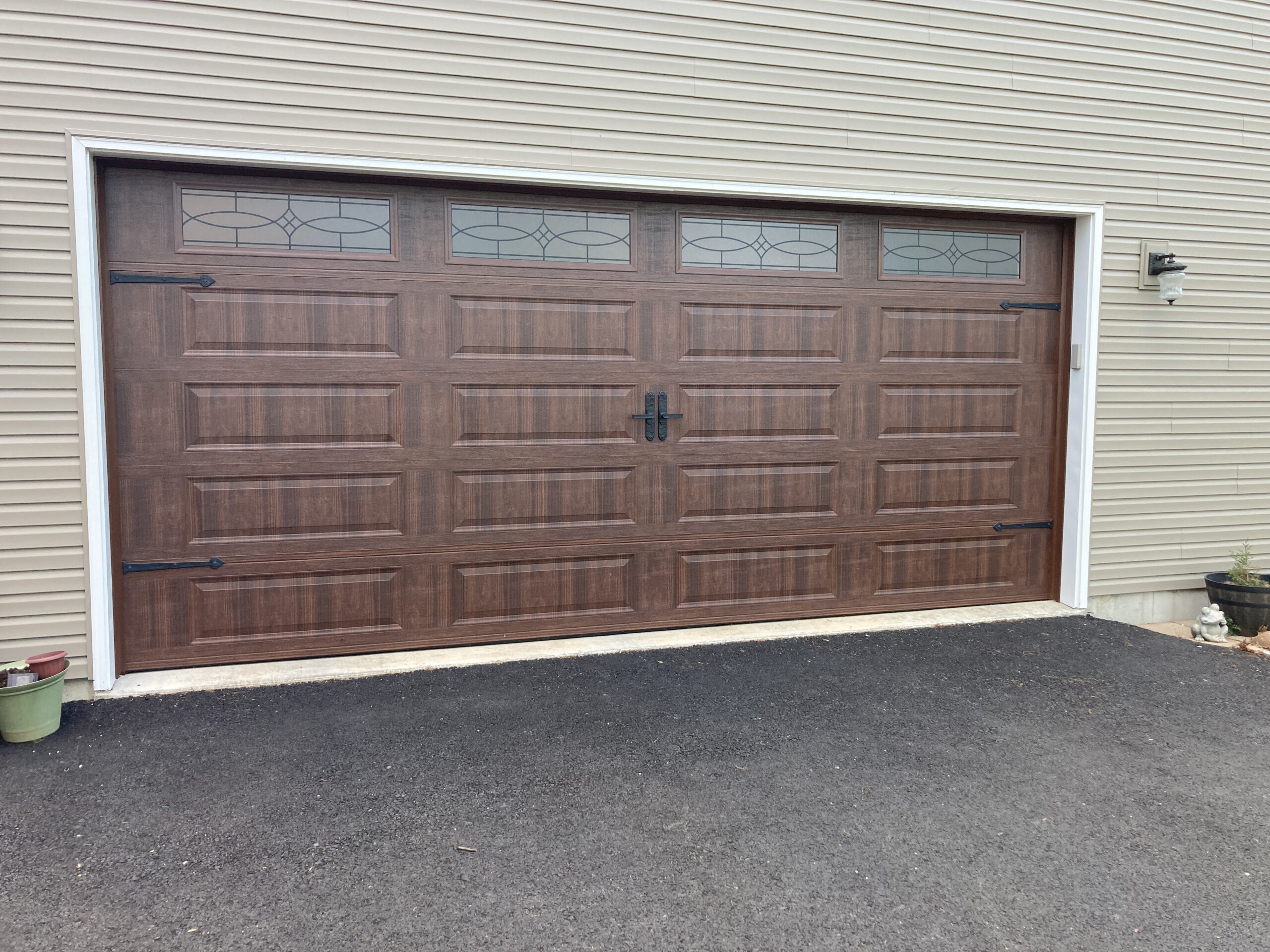 Faux wood long panel garage door with windows and hinges